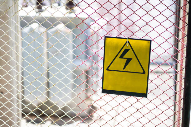 istock High voltage hazard sign on steel grid in dangerous areas 1478658745