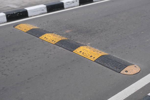 istock Speed bump on black and yellow asphalt 1478660630