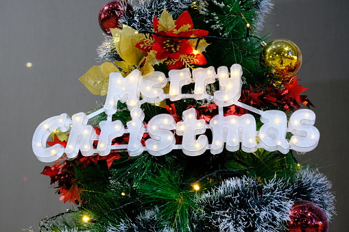 Close up of merry Christmas text lamp in Christmas tree