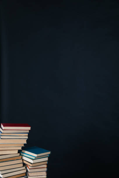 large number of books stacked on a black background in the library science knowledge