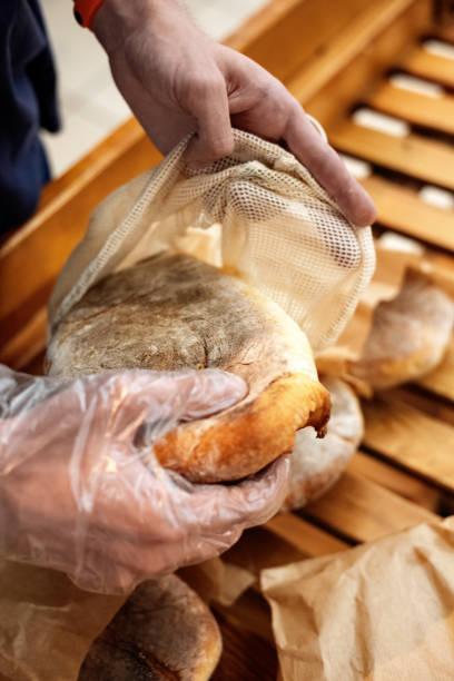 istock Man in supermarket with eco bag taking bread 1478666699