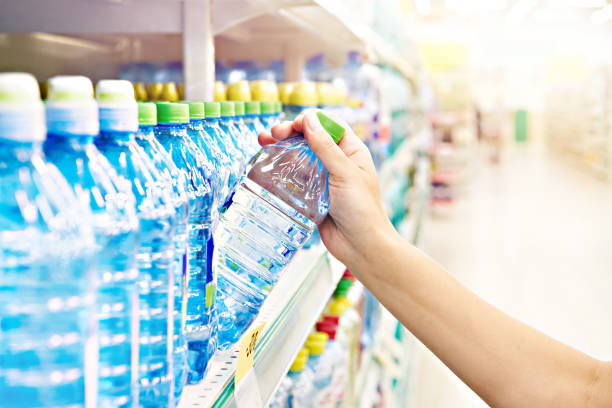 istock Hand with drinking water at shop 1478670751