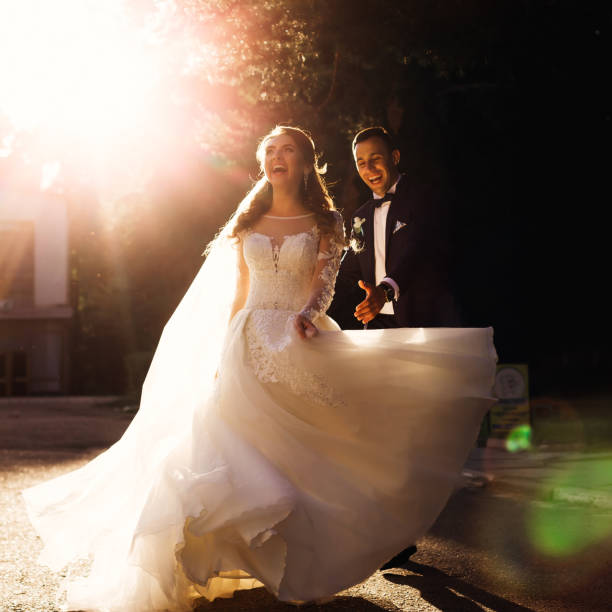 Smiling mexican bride poses outdoors, holding a beautiful flower bouquet. The image conveys happiness and romance.