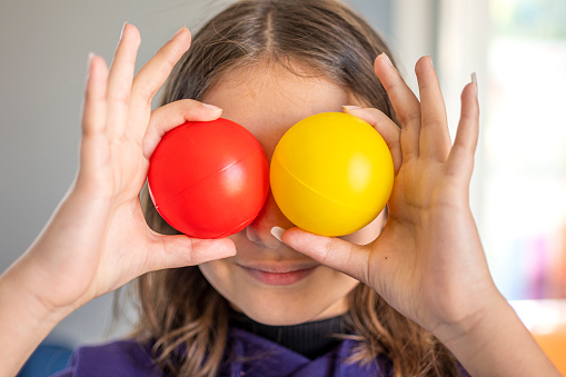 Little girl playing with multi colored balls