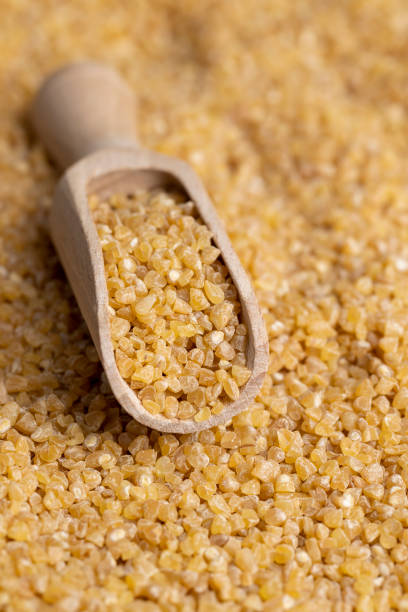 istock Not cooked wheat porridge with a wooden spoon 1478681548