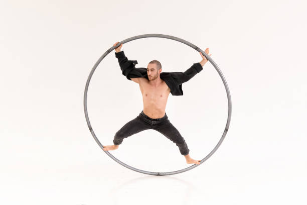 istock Cyr wheel artist in white room 1478681813