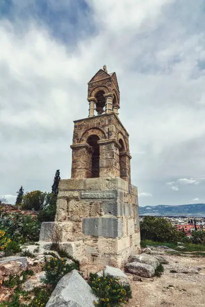 Scenic bell tower view of Panaghia Mesosporitissa a Byzantine single-aisled cruciform church at the archaeological site of Eleusis, Attica Greece.