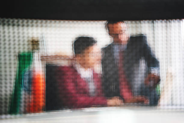 Friendly and happy Caucasian male boss looking and smiling at his worker during the meeting. pleased and satisfied facial expression