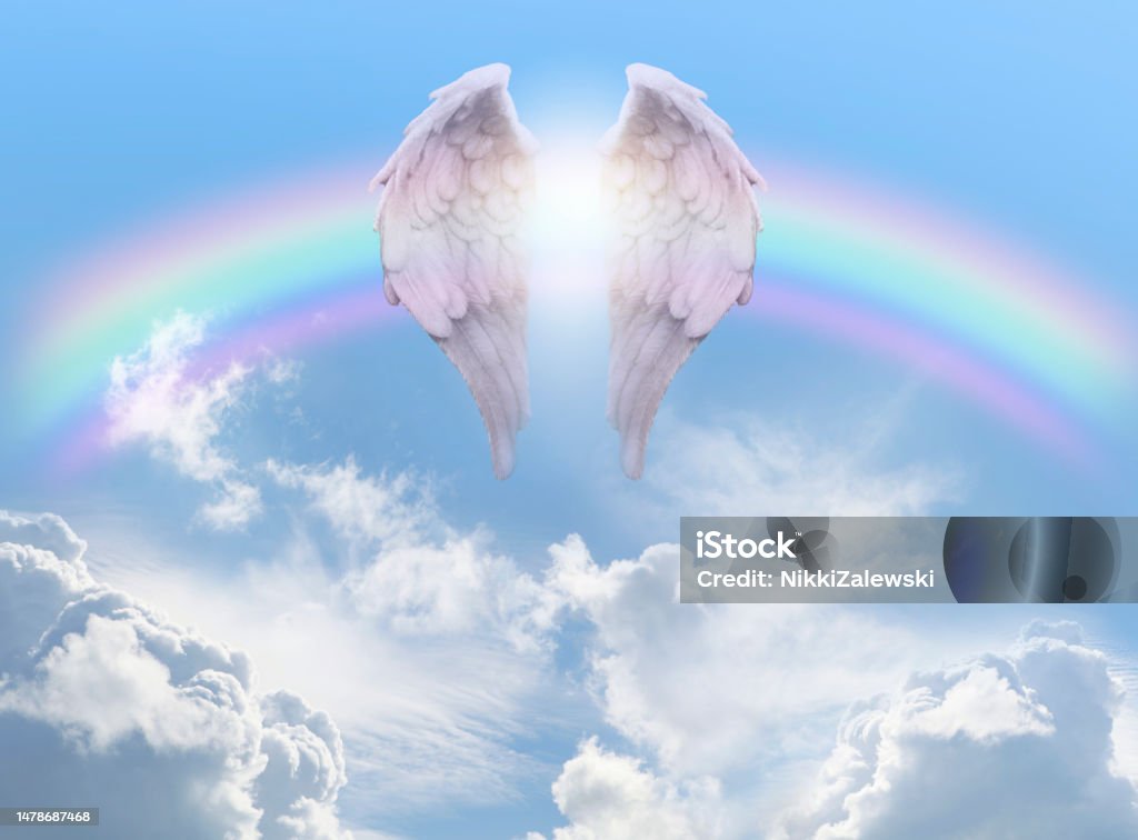 Angel Wings Rainbow Blue Sky Background pair of angel wings infront of a rainbow arc against a beautiful blue sky with fluffy clouds ideal for a spiritual or religious blessing theme Angel Stock Photo