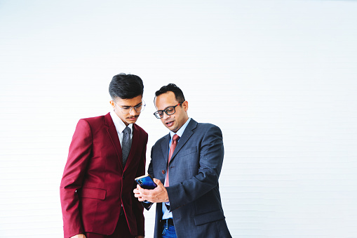 Two Businessmen exchanging information by smart phones