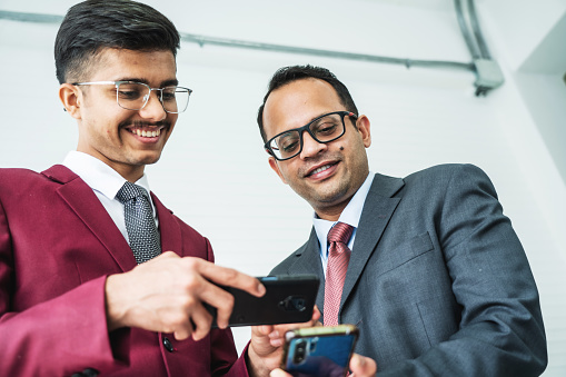 Two Businessmen exchanging information by smart phones