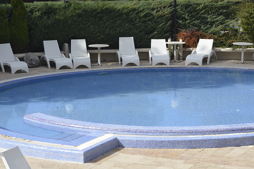 Hotel swimming pool with children's playground and furniture
