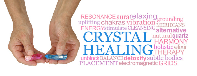female hands holding a pink and a blue terminated aura crystal in each hand beside a relevant word cloud isolated on white background