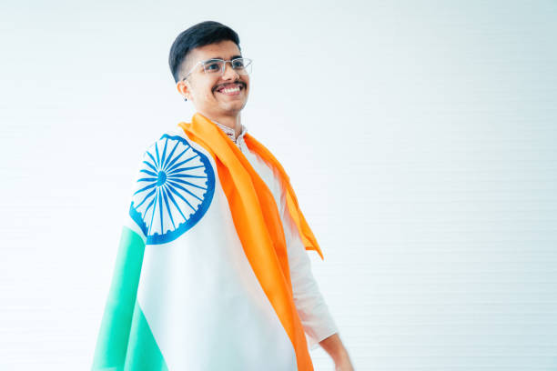 Happy businessman with indian flag while watching football match