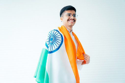 Happy businessman with indian flag while watching football match
