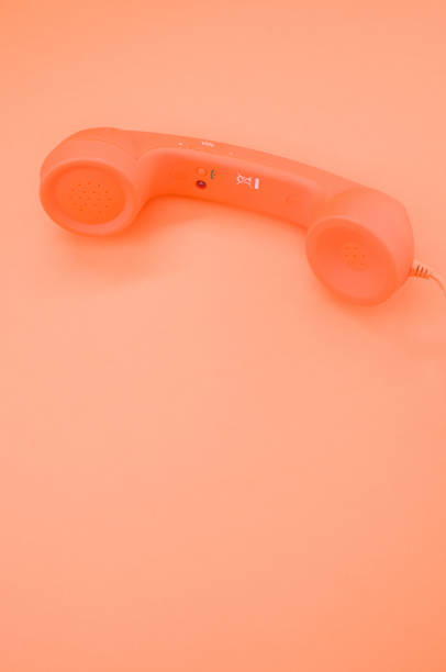 istock Vertical shot of a classic handset on pastel orange background for a copy space 1478690249