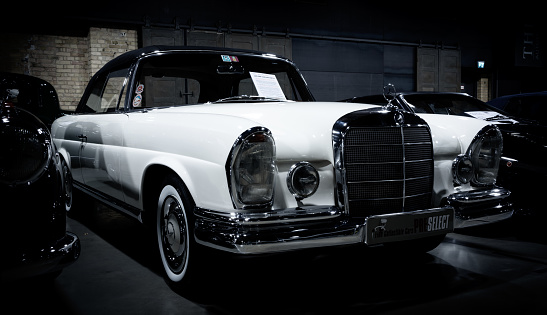 Berlin, Germany – January 15, 2021: GERMANY Nov 25, 2020. 1962 white Mercedes Benz 220 Seb Cabriolet W111 , Classic car in a public exhibition in Berlin.