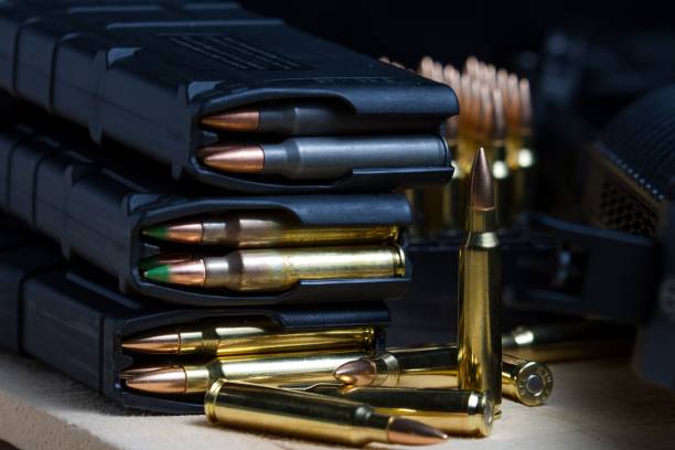 istock 223 rifle ammunition bullets in a loaded mag arranged in front of an AR-15 rifle 1478690708