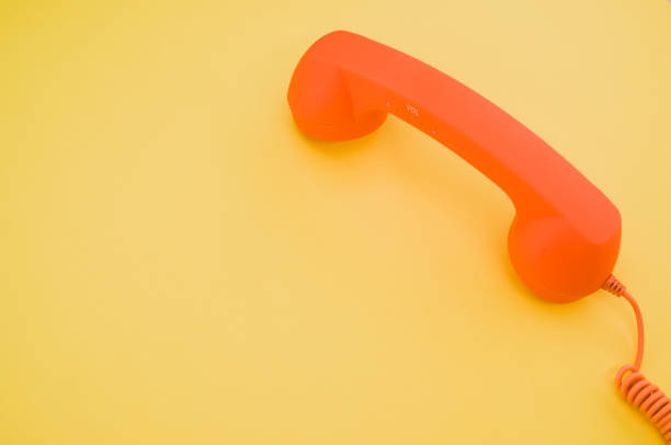 istock Classic orange handset on pastel yellow background for a copy space 1478690731