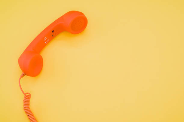 istock Classic orange handset on pastel yellow background for a copy space 1478690735