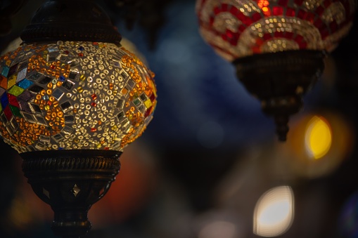 A selective focus of a lamp with colorful mosaic patterns