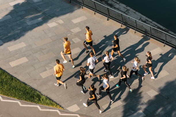 Aerial shot of people running on the waterfront stock photo