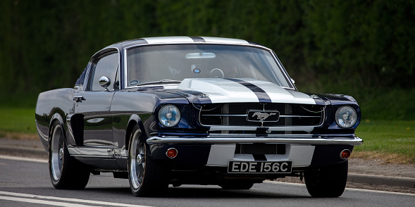 Bicester, Oxon., UK - April 24th 2022. 1965 Ford Mustang car travelling on an English country road
