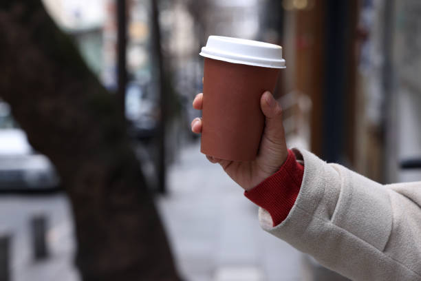 istock Close up hand holding a white coffee paper cup 1478697979