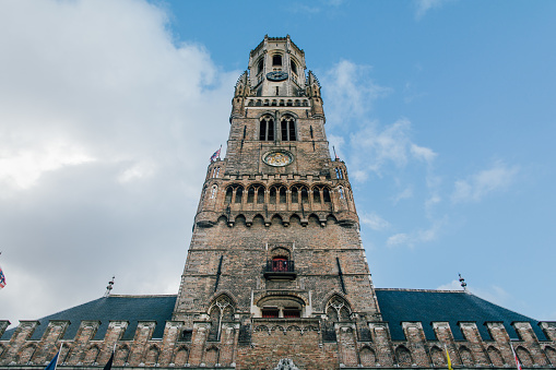 The low angle shot of the Belfry of Bruges belltower