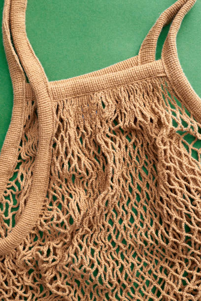 istock Brown color mesh eco bag on green background 1478699954