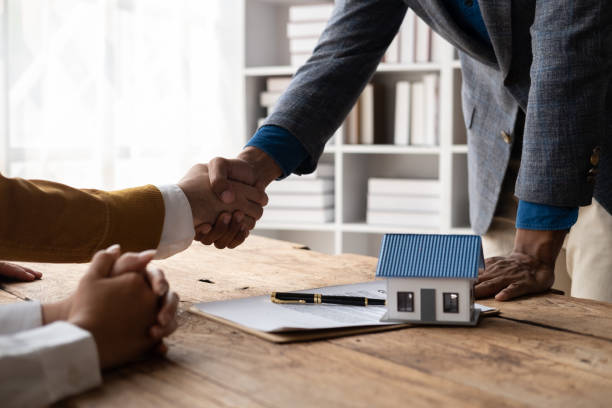istock Real estate agent shaking hands with his customer after contract signature. 1478700504