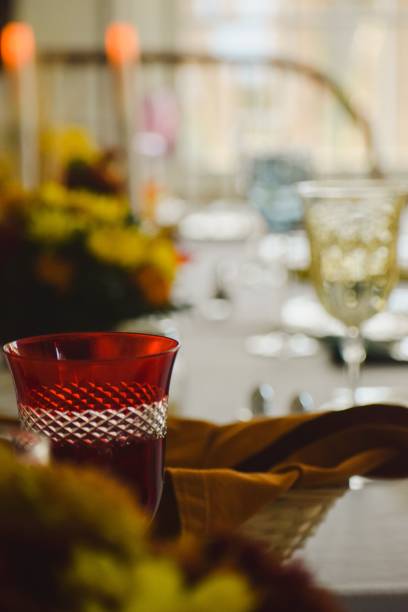 istock Vertical shot of a red glass cup on a table in a blurred background 1478701128