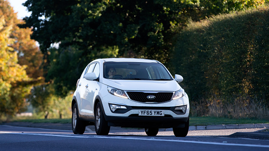 Bicester,Oxon,UK - Oct 9th 2022. 2015 white 1591 cc Kia Sportage travelling on an English country road