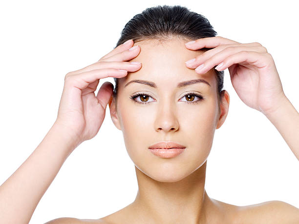 istock Woman touching her forehead without wrinkle 147870690
