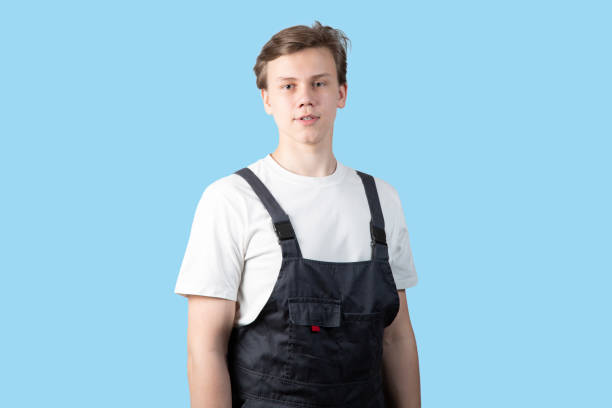 istock A young man in overalls on a white background. 1478712224