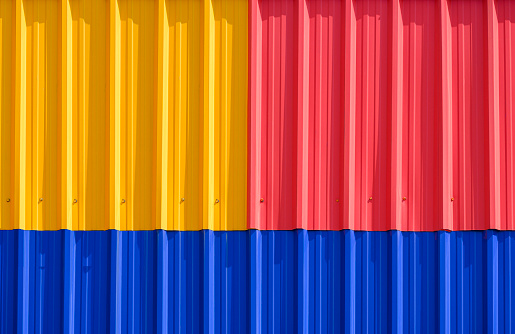 Background and Texture of Colorful red, yellow and blue Corrugated Steel fence Wall decoration, front view with copy space