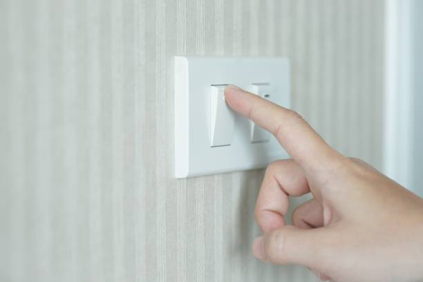 istock Female finger is turn off on lighting switch 1478714374