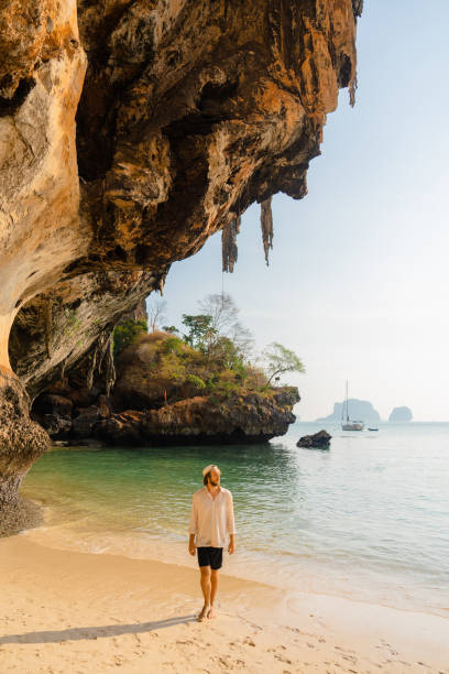 istock Man walking on Railey beach and looking at stunning scenery 1478714890