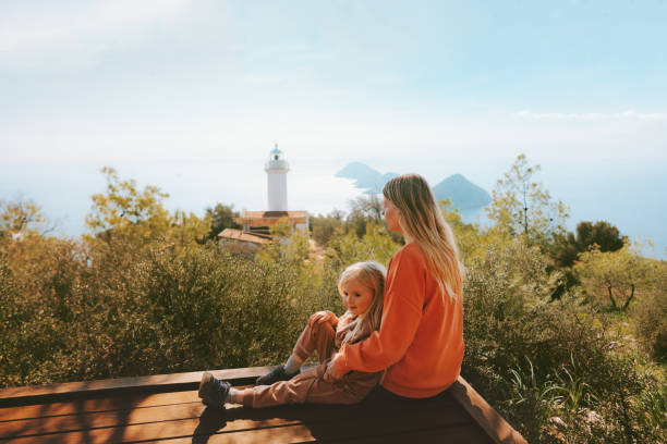 Mother and child traveling in Turkiye outdoor family summer vacations lifestyle hiking Lycian way Gelidonya lighthouse landscape stock photo