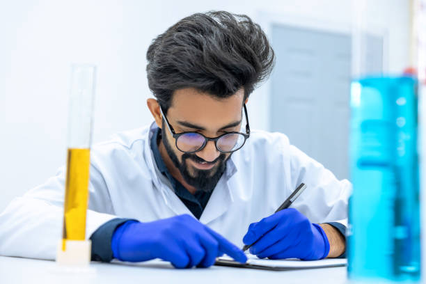 istock Scientist examining liquid in test tube in laboratory. 1478718170