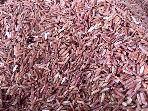 Close-up photo of red rice grains believed to have high nutritional value.
