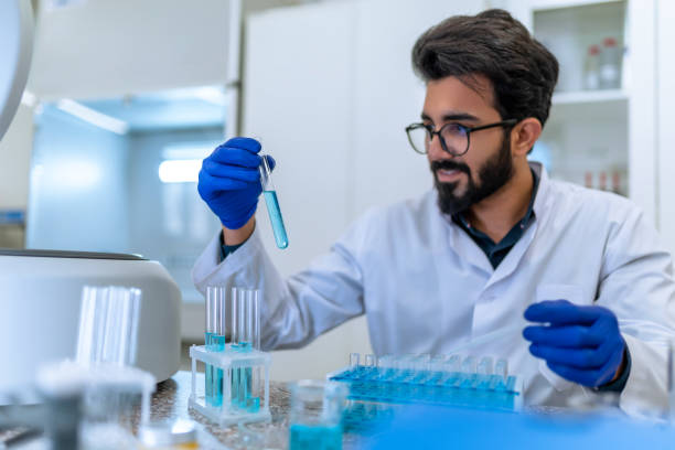 istock Successful scientist man testing chemical sample in flask at laboratory with lab glassware. 1478718889
