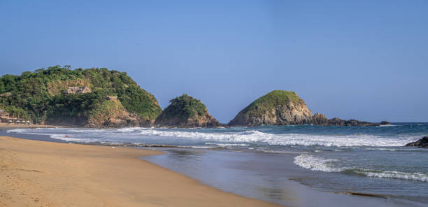istock Beach, waves, and hills covered with jungle in the background 1478722612