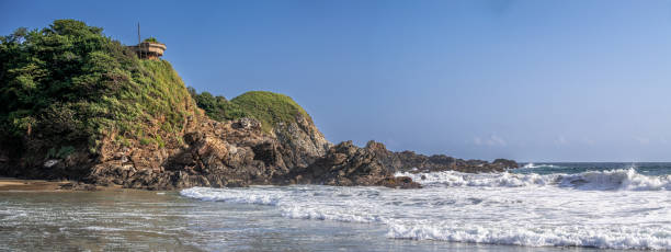 istock Beach, waves, and hills covered with jungle in the background 1478722696