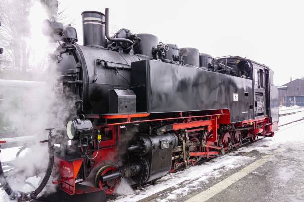 istock an old fashioned steam engine is traveling down the train tracks 1478722754