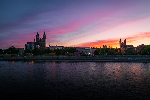 A beautiful view of the Elbe river and Magdeburg cathedral at sunset in Germany.