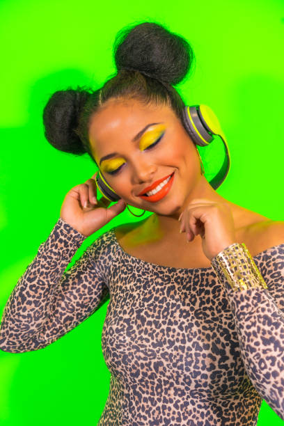 happy cool hispanic girl with bright makeup and two tails hairstyle enjoying music with headphones - head and shoulders audio imagens e fotografias de stock
