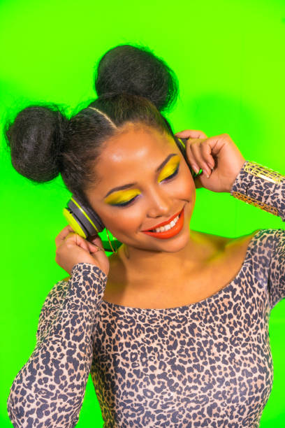 happy cool hispanic girl with bright makeup and two tails hairstyle enjoying music with headphones - head and shoulders audio imagens e fotografias de stock