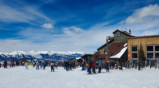 Keystone, Colorado, USA- March 29, 2023: Crowd of skiers in front of Summit House at the top of River Run Gondola. Keystone ski resort, Colorado.