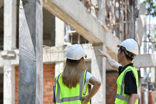 istock Construction engineer and architect point to the construction site. wearing safety vests and helmets for safety. 1478727983